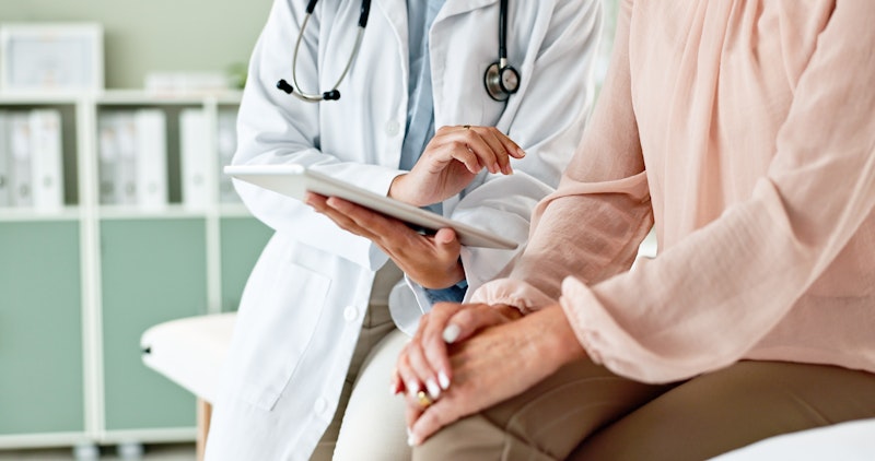 Doctor With Patient Using Ipad