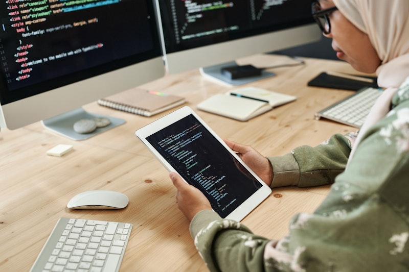 Woman Developer Using Ipad And Computer For Code