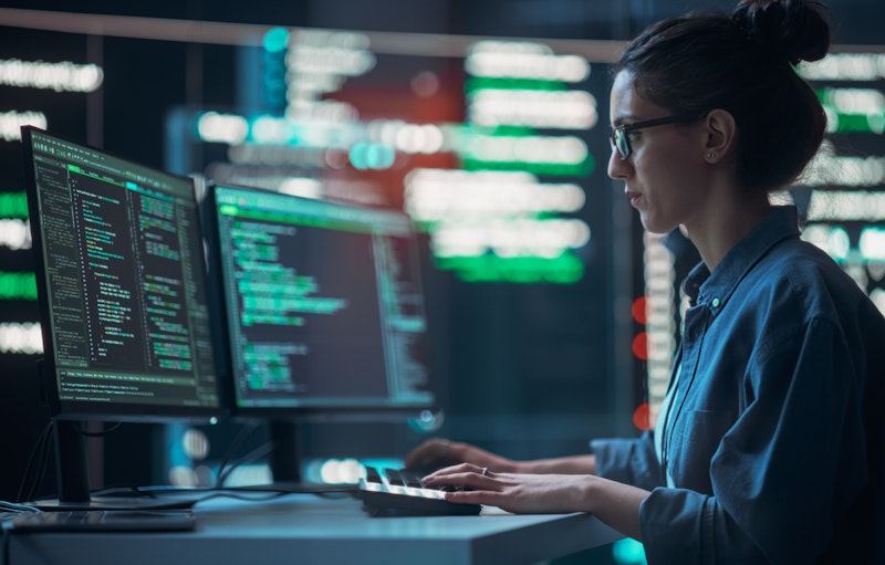 Woman Writing Code In A Dark Room