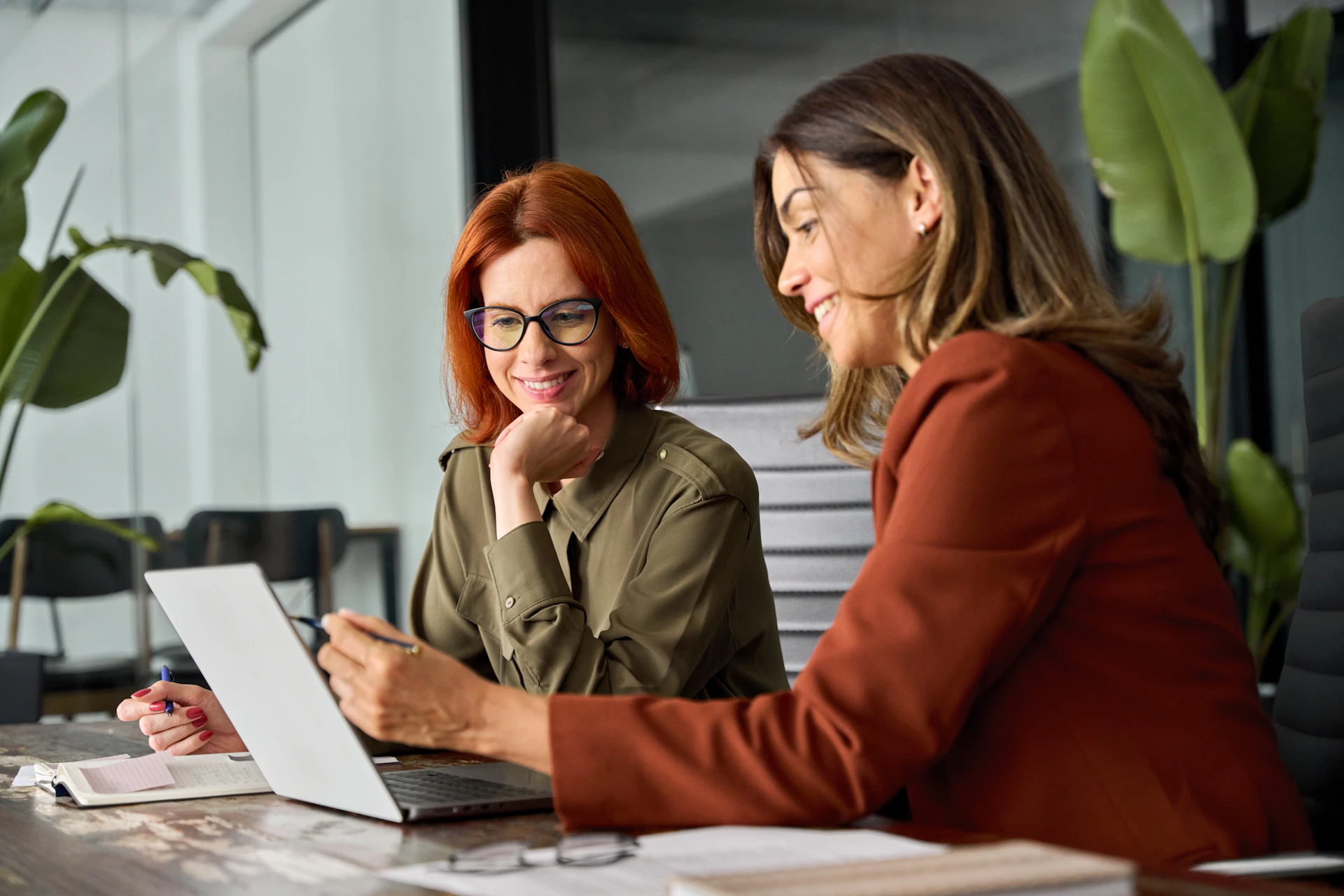 Two Women Looking At Dte On A Computer