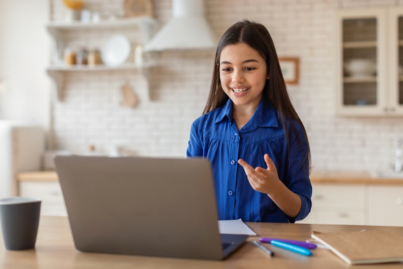 Younger Girl Answering A Question On A Virtual Class